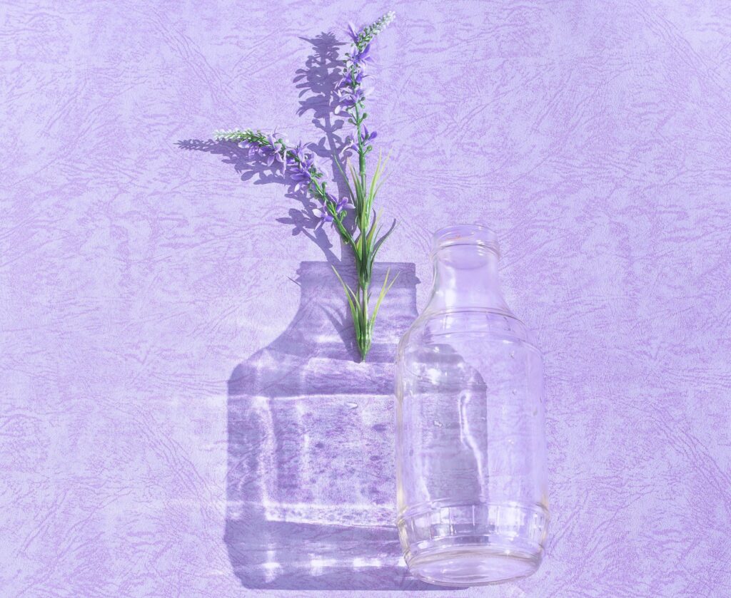 A picture of a jar and lavender leaves on the side on a lavender colour sheet of paper representing scent marketing